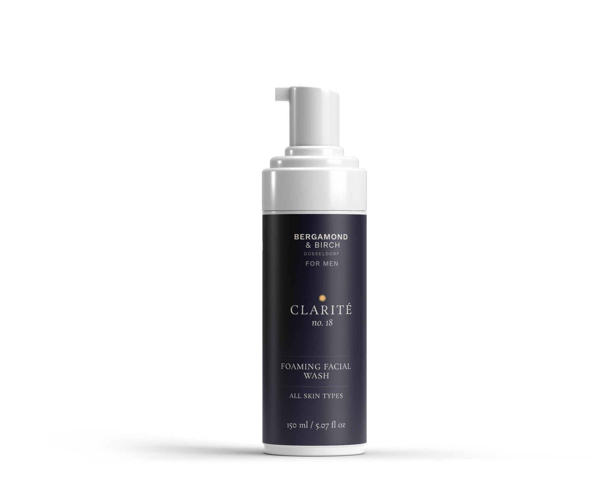 A sleek navy and white bottle labeled “CLARITÉ No. 18 – Foaming Facial Wash for Men” by Bergamond & Birch. Pump dispenser on top, minimalist design, placed on a white background.