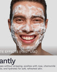 Smiling man with fresh foam lather on face, demonstrating immediate cleansing and soothing effects of Bergamond & Birch Clarité No. 18 Foaming Facial Wash.