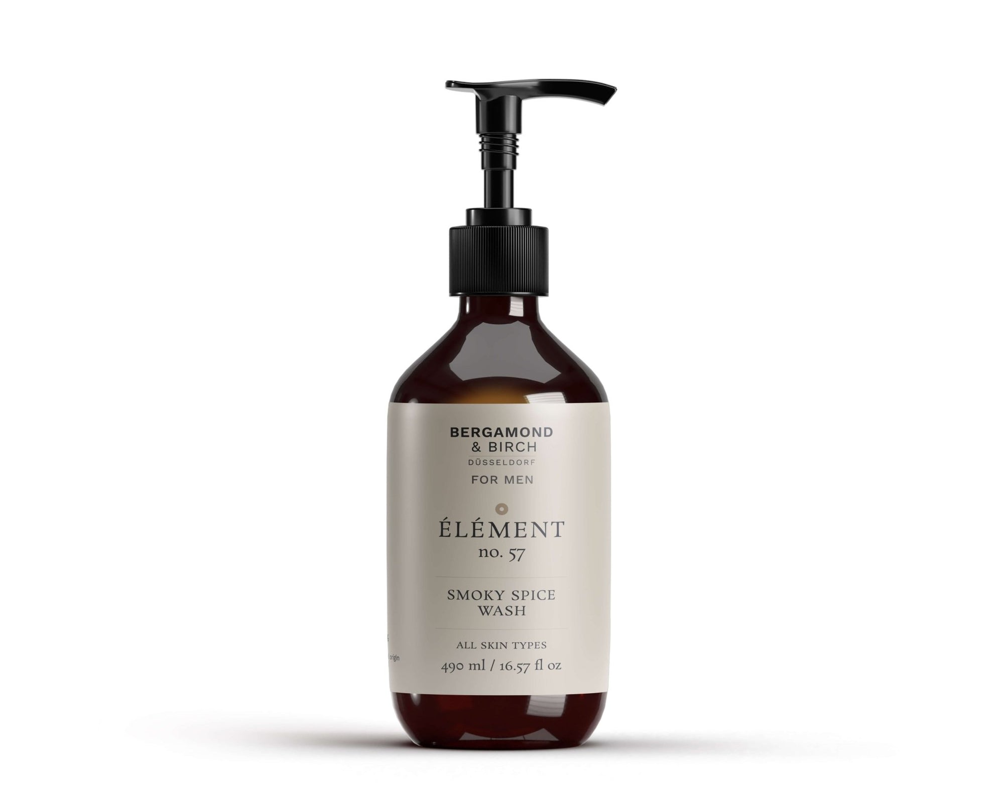 A dark amber bottle with a black pump labeled “Smoky Spice Wash – For Men” by Bergamond & Birch. Minimalist cream label, placed on a white background. Natural body wash for all skin types.