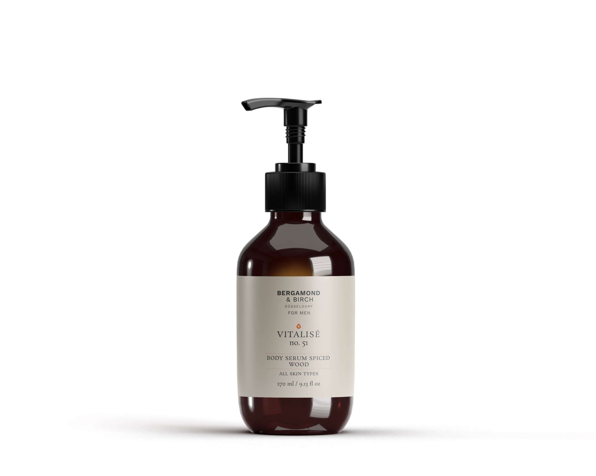 A premium amber-toned bottle of Vitalise No. 51 – Body Serum Spiced Wood from Bergamond & Birch. The sleek pump bottle features a minimalist ivory label and stands against a crisp white backdrop, reflecting an earthy, masculine scent profile. Designed for all skin types and a refined grooming experience.